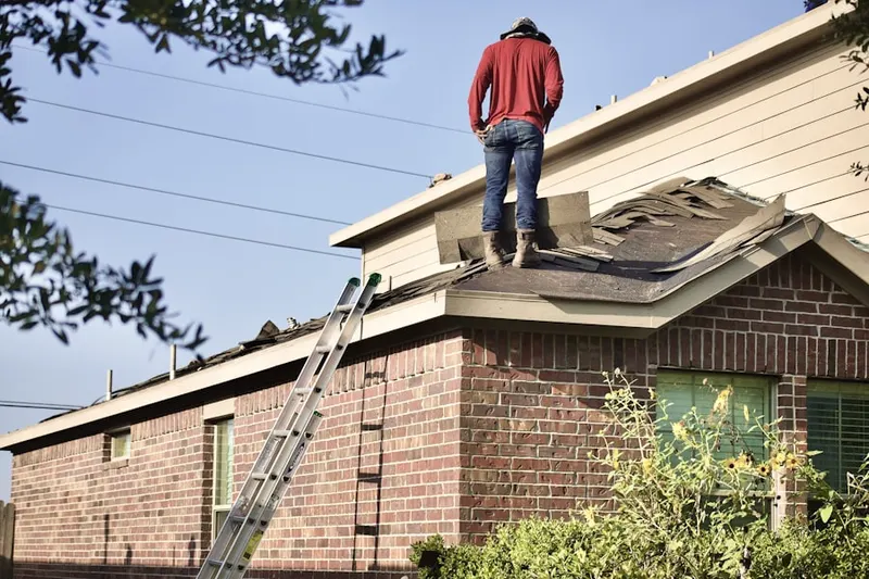 Professional roofer working on a residential roof in Brockport